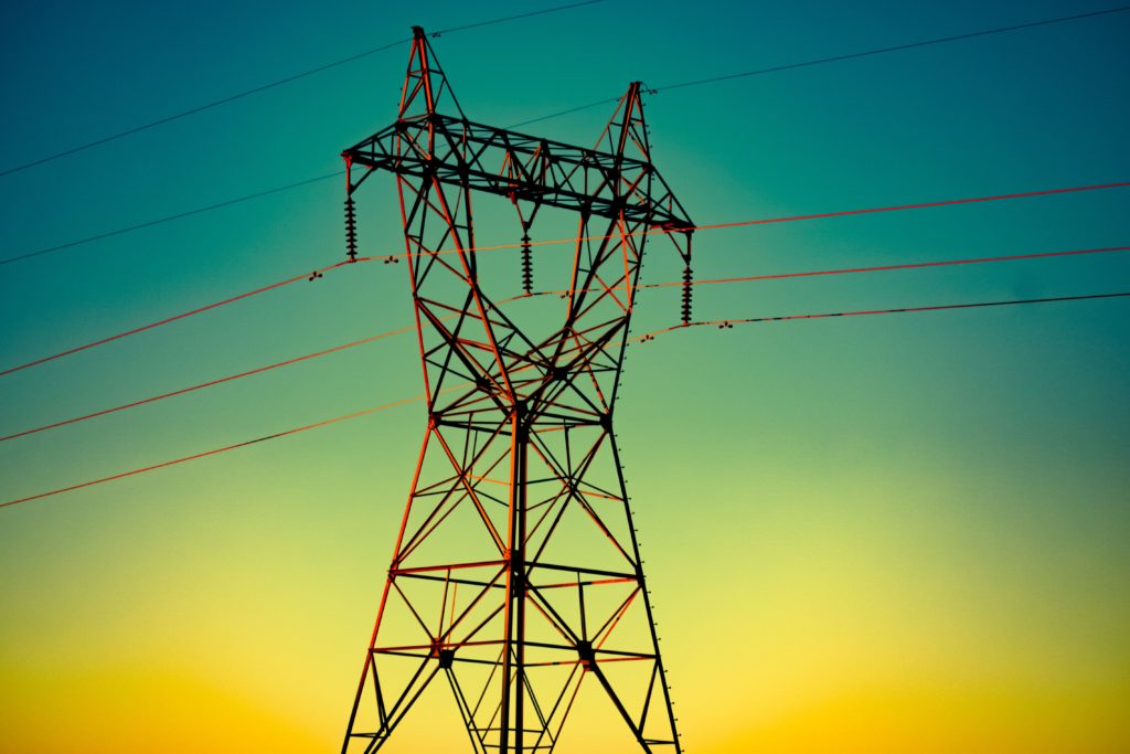 A transmission tower against a gradient background.
