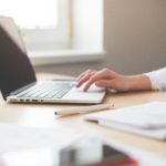 A woman works on a laptop.